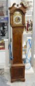 Walnutwood grandmother clock with swan-neck pediment, pair pillars flanking the hood,