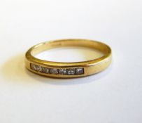 18ct gold half-eternity ring having row of channel set princess-cut diamonds