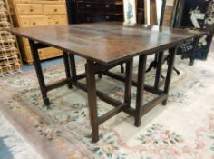 Late 18th/early 19th century oak square gateleg table on square supports,