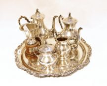 Four piece tea and coffee set of baluster form on a pedestal base, having scroll finials to lids,