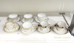 Pair of early 19th century teacups and saucers decorated with a band of rust-coloured fruiting vine