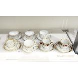 Pair of early 19th century teacups and saucers decorated with a band of rust-coloured fruiting vine