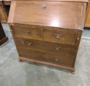 An oak writing desk, the fall to reveal fitted interior,