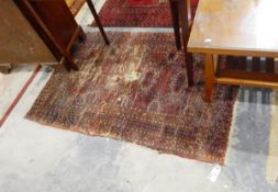 An Eastern style rug, dark browns and reds with cream,