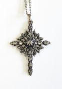 Georgian gold coloured metal and paste/diamond cross pendant of openwork stylised leaf pattern set