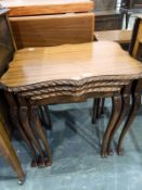Walnut nest of three occasional tables with shaped tops with gadrooned edging,