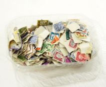 A quantity of loose postage stamps of various nations together with a Chad Valley tin coin box with