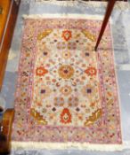 Eastern style wool rug , bordered with mauve,