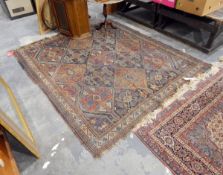 An Eastern wool rug, dark blues, browns ,