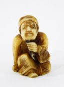 Late 19th c. /20th c. Japanese carved ivory netsuke, man seated and pulling beard (cracked), 3.