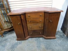Hardwood inverted breakfront dressing table having four graduated drawers to centre flanked by two