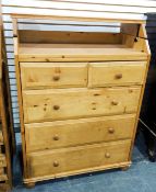 Chest of two short and three long drawers with fall-flap top section, on bun feet,