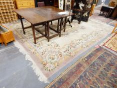A large Aubusson style rug with elaborate foliate design border and central medallion 380 x 280 cms
