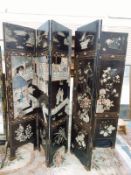 A Chinese lacquer six-fold screen, carved and painted with interior scenes,
