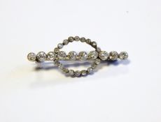 Early 20th century diamond bar brooch set with 10 Swiss cut diamonds to centre bar and surrounded