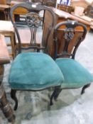 Graduated pair of Victorian salon chairs with floral carved splats,