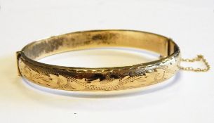 9ct gold bangle, partly foliate scroll engraved,