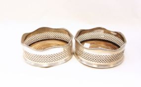 Pair of silver wine bottle coasters, each with serpentine gadrooned edge, pierced gallery sides,