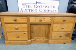 Nineteenth century pine low dresser with an arrangement of six drawers and cupboard below,