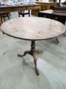 Georgian oak tilt-top table on turned tapered column, tripod scroll supports, pointed pad feet,