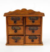 Miniature pine chest of six short drawers, bearing metal labels for spices,