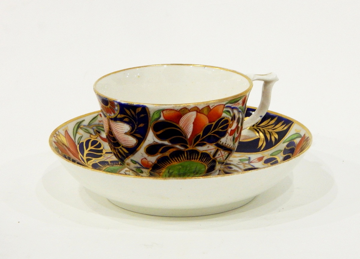 A set of five Victorian Crown Derby teacups and saucers decorated with flowers,