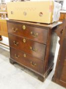 Small oak chest of three long graduated drawers, on shaped bracket feet,