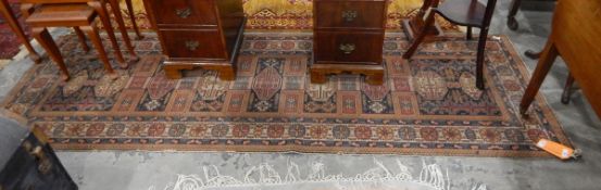 A Persian style runner with grey and red ground, cream borders, geometric pattern,