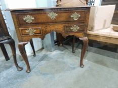 George III oak cross-banded lowboy with one long and two short drawers,