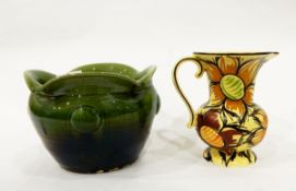 Art pottery vase decorated with brown flowers on a yellow ground,