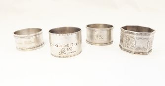 Three silver napkin rings and another silver plated napkin ring together with a manicure tool,