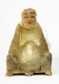 An Oriental carved jade seated figure of a sage,