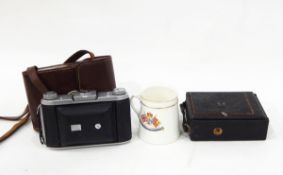 Ensign Selfix 820 camera in leather case, various camera plates, a commemorative tin and mug, etc.