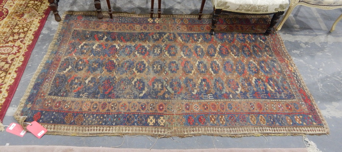 An Eastern wool rug, blue, cream and orange, floral borders,