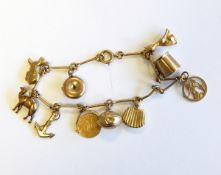 A gold charm bracelet, marks rubbed, approx. 11.