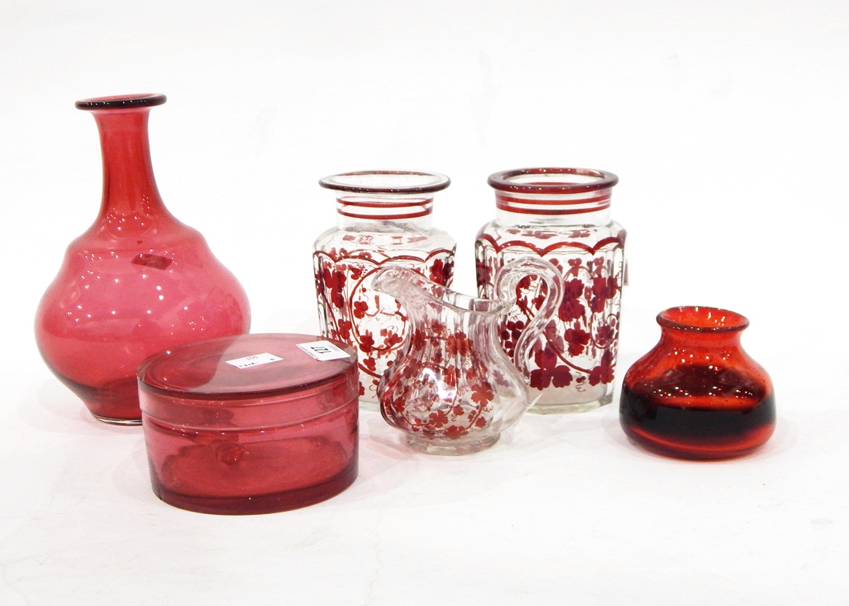 Cranberry glass dressing table box and cover of plain circular form, a cranberry glass carafe,