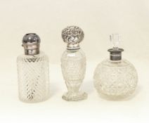 Three late 19th century cut glass scent bottles with silver mounts