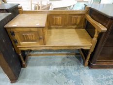 Oak telephone seat with linenfold carved decoration to single cupboard and back,