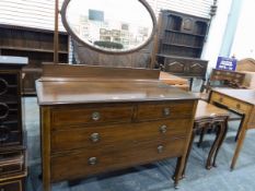 Mirror-backed dressing chest of two short and two long drawers with circular handles,