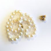 A cultured pearl necklace and a pair similar earrings,