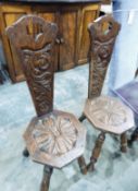 Pair of continental-style carved oak hall chairs with floral and scroll decoration, octagonal seats,