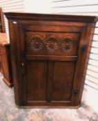 19th century oak corner cabinet with floral and guilloche patterned panel,