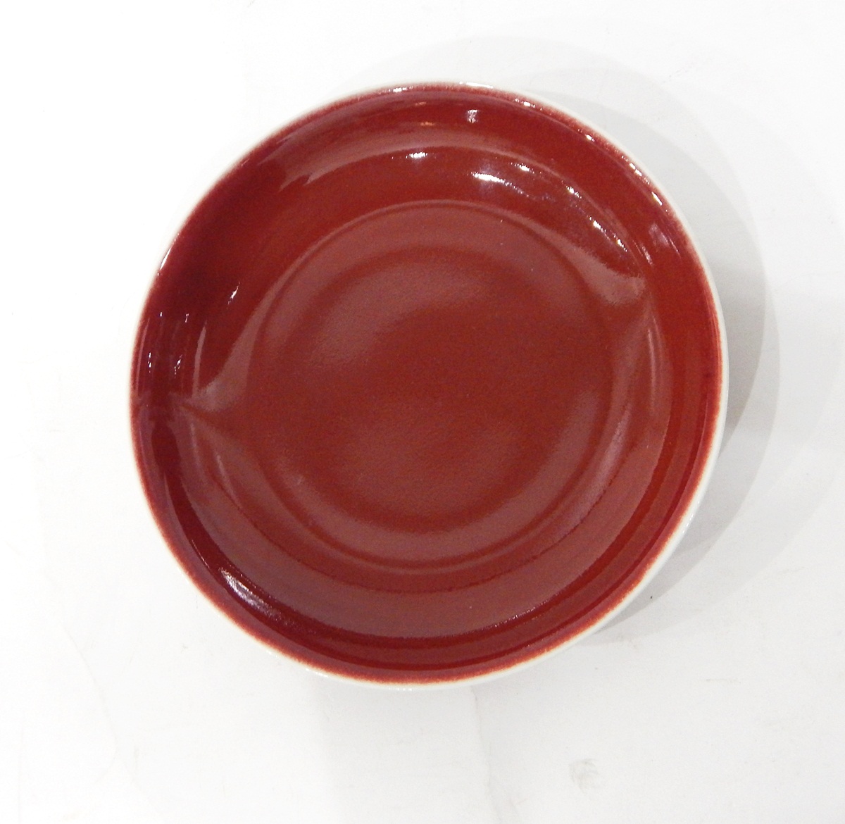 Chinese dish of plain form in red flambe glaze, character marks to base,
