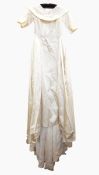 Cream satin wedding dress with boat-neck, deep collar, three-quarter length sleeves, full train,