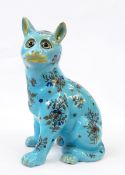 Possibly Mosanic cat in seated position with floral pattern, on dusty blue ground, glass eyes,