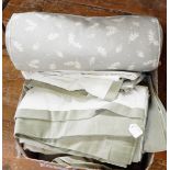 Box of various linens including a fabric covered bolster, two pairs of green curtains, etc.