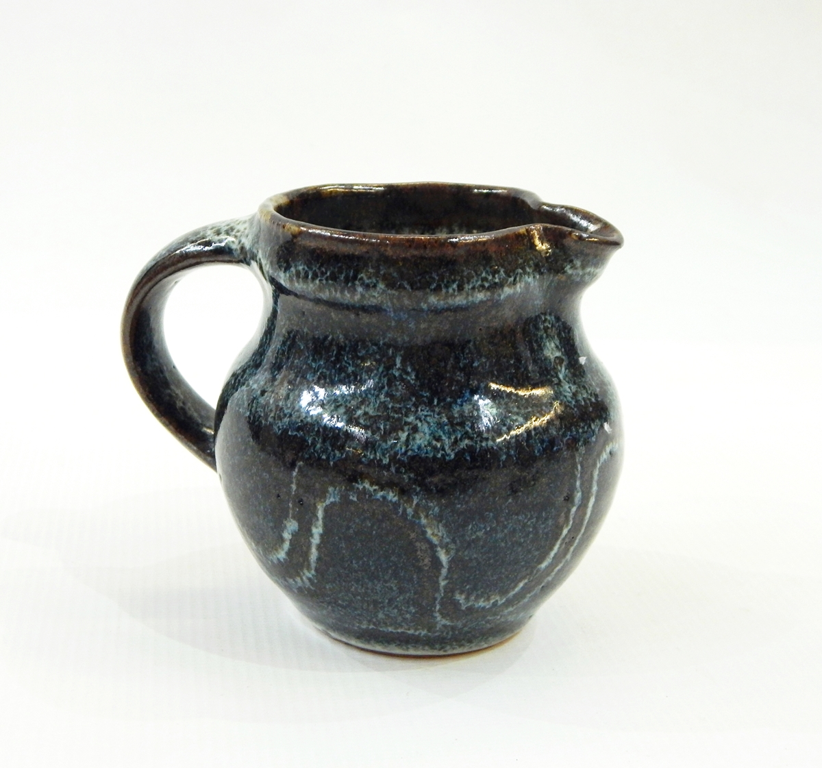 Ray Finch Winchcombe small pitcher, blue ground with wax resist meander decoration, stamped to base,