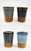 Ray Finch Winchcombe set of four glaze trial beakers, various ash finishes, stamped to base,