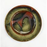Ray Finch Winchcombe poured-glaze charger with mottled green slip over rust groud, stamped to base,