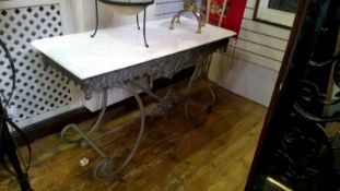 Cast iron and marble-topped table on scroll supports,